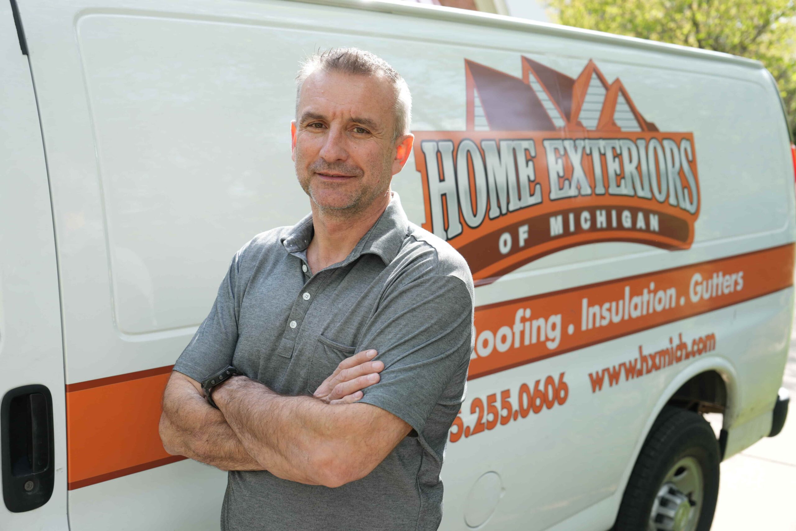Home Exteriors of Michigan team member with company van